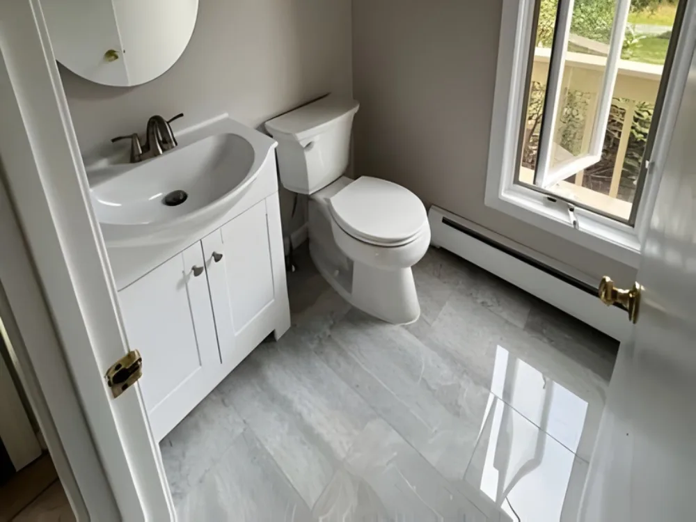 half bath renovation with new vanity, toilet, and gray tile floor