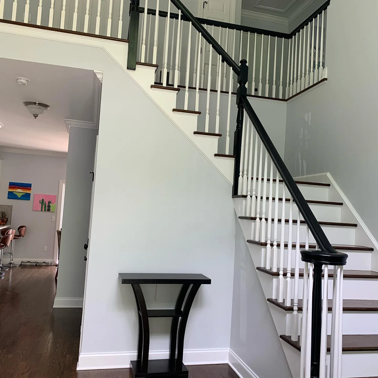 Modern foyer featuring professional interior painting on high walls and white trim.