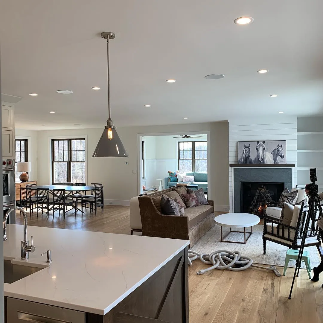 Modern farmhouse interior painting in a bright living room and dining area featuring clean white walls.