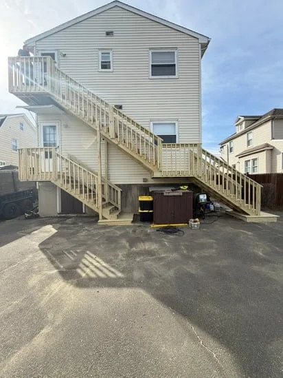 Full side profile of the finished exterior stair replacement on a residential home.